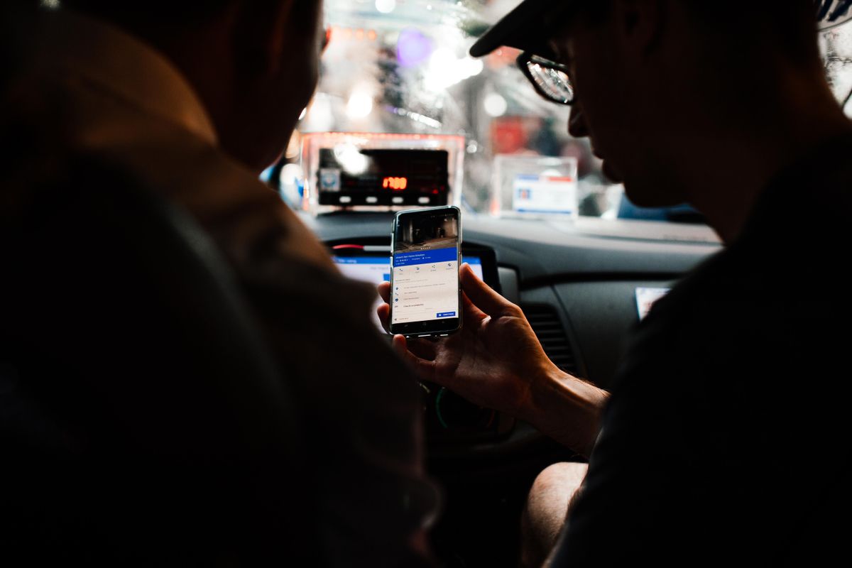 Passenger using a phone inside a taxi